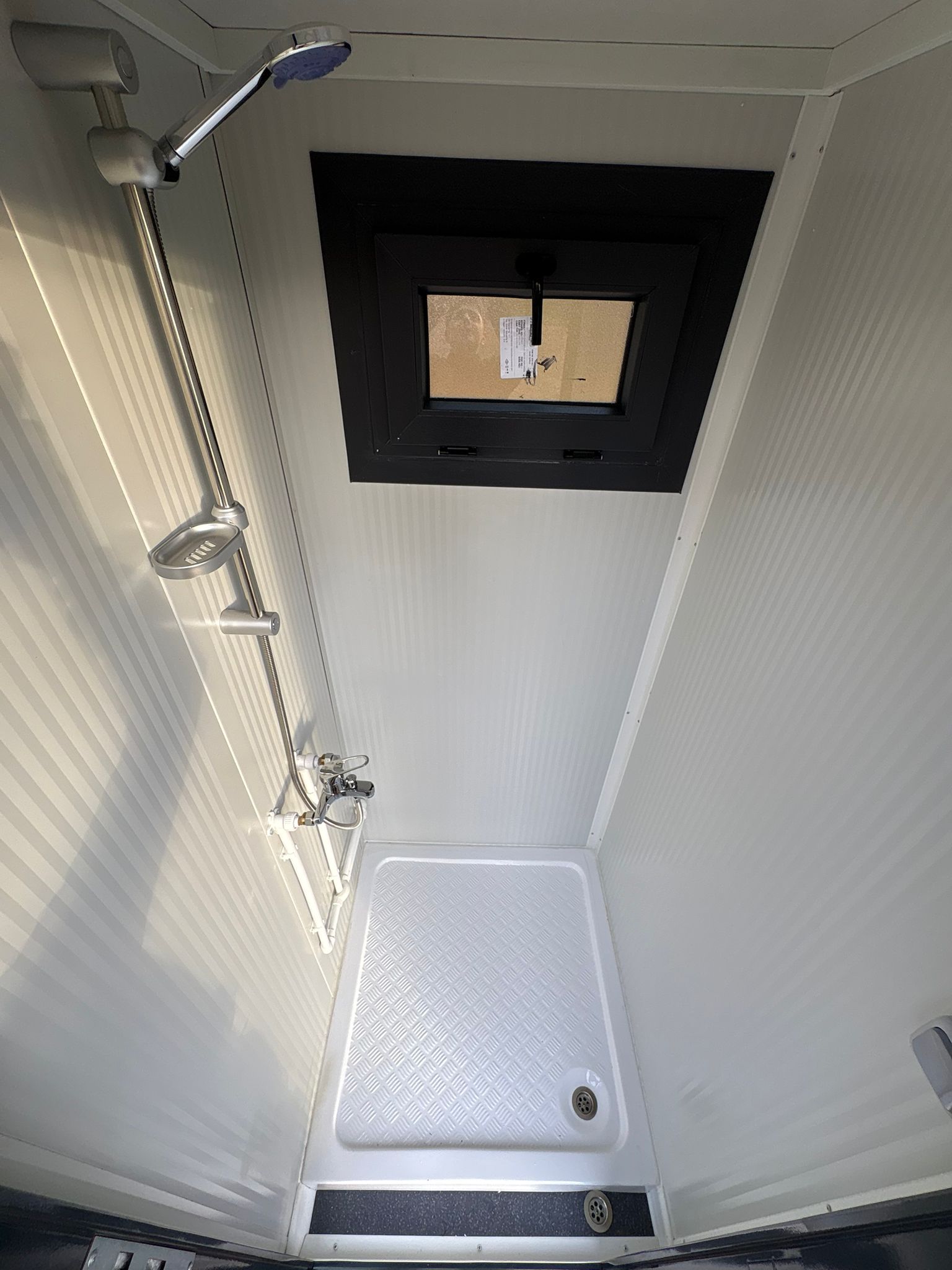 Doucheruimte van een toilet- en doucheunit.