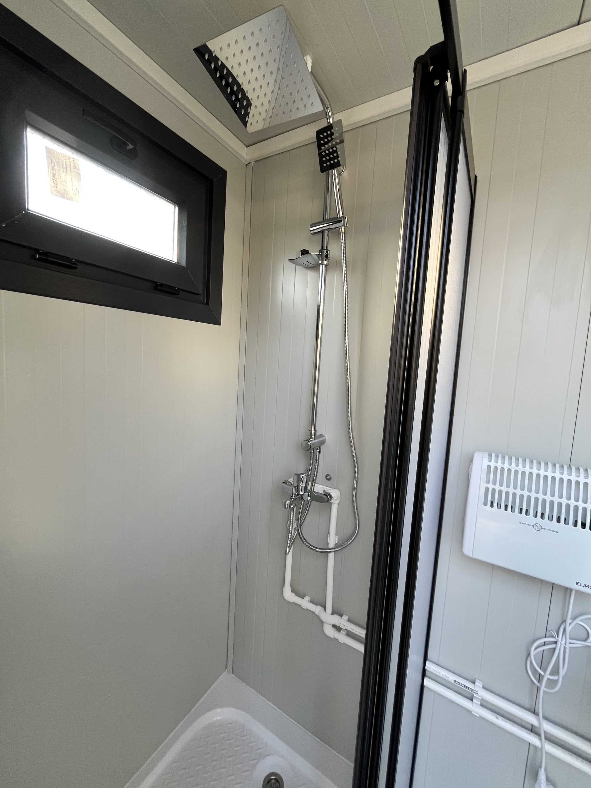 Close-up van doucheruimte in mobiele badkamer unit met 4 ruimtes