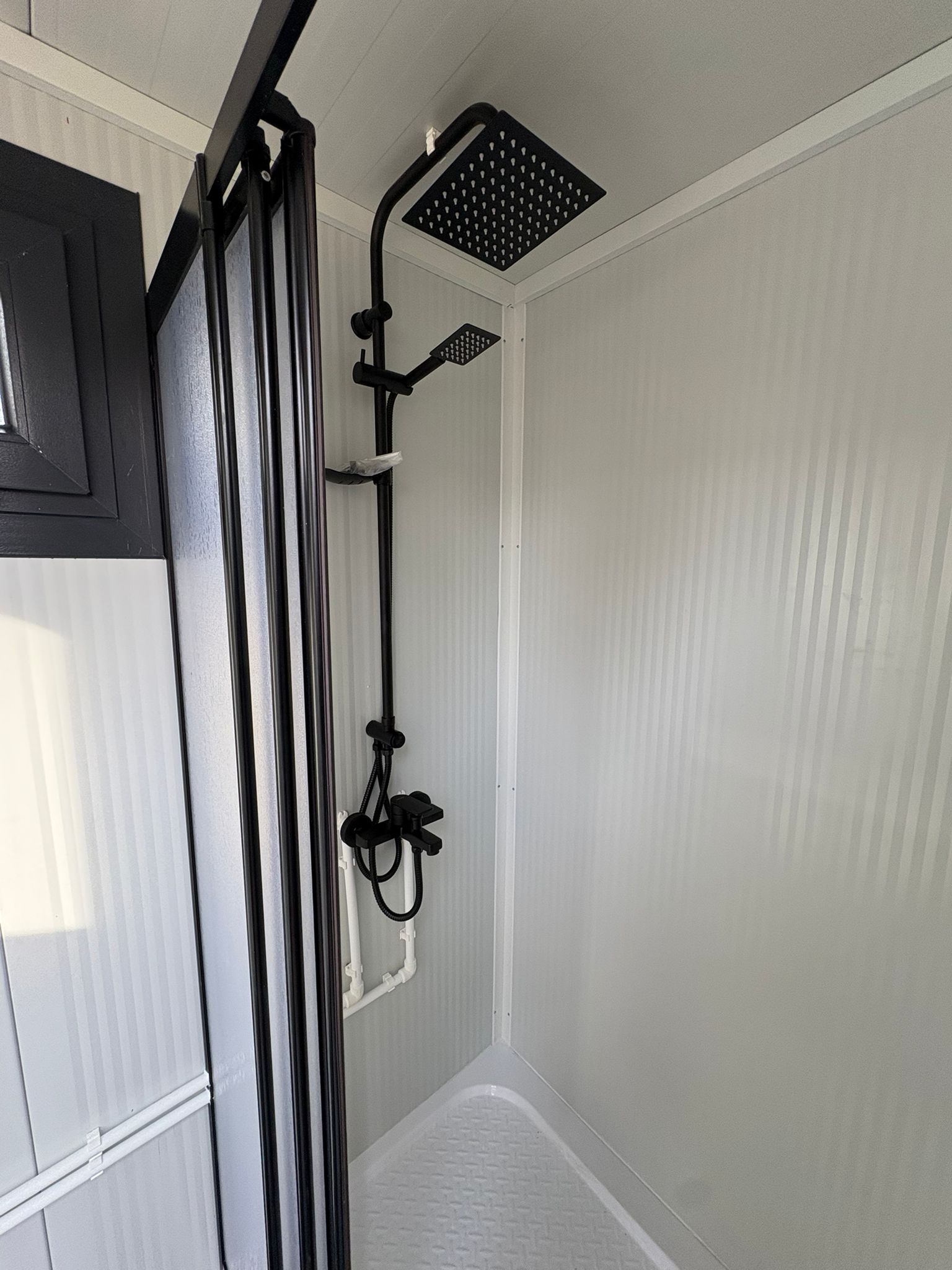 Regendouche van een doucheunit met omkleedruimte.