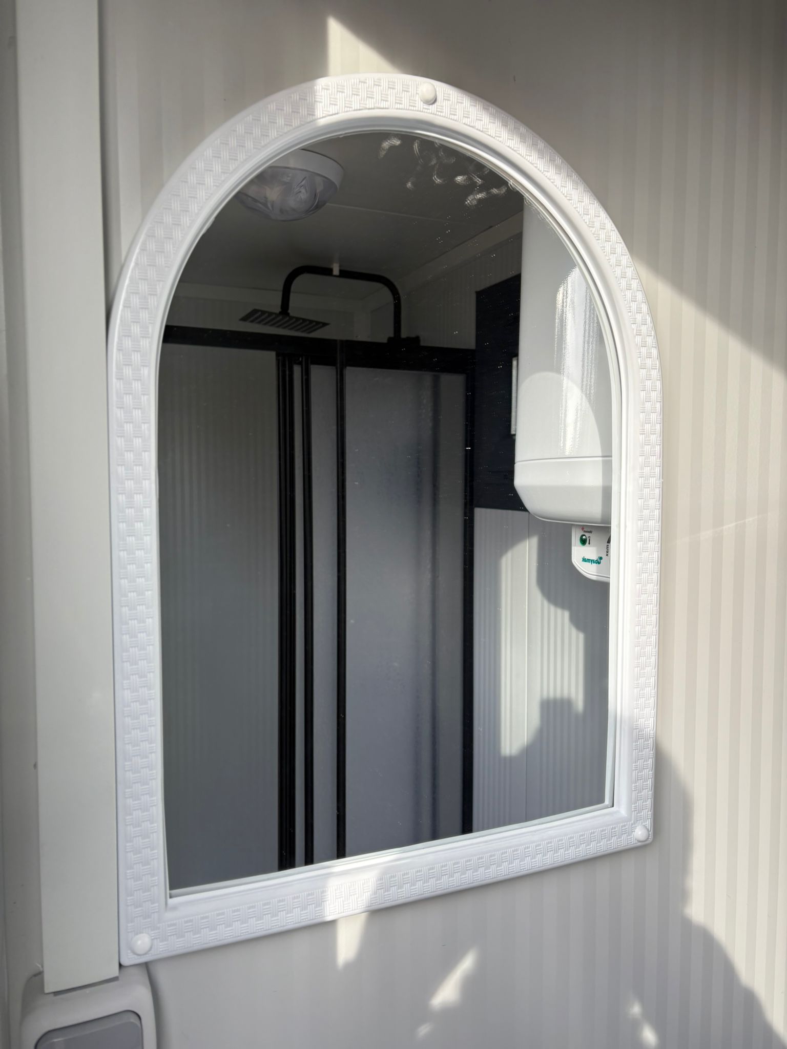 Spiegel in een doucheunit met omkleedruimte.