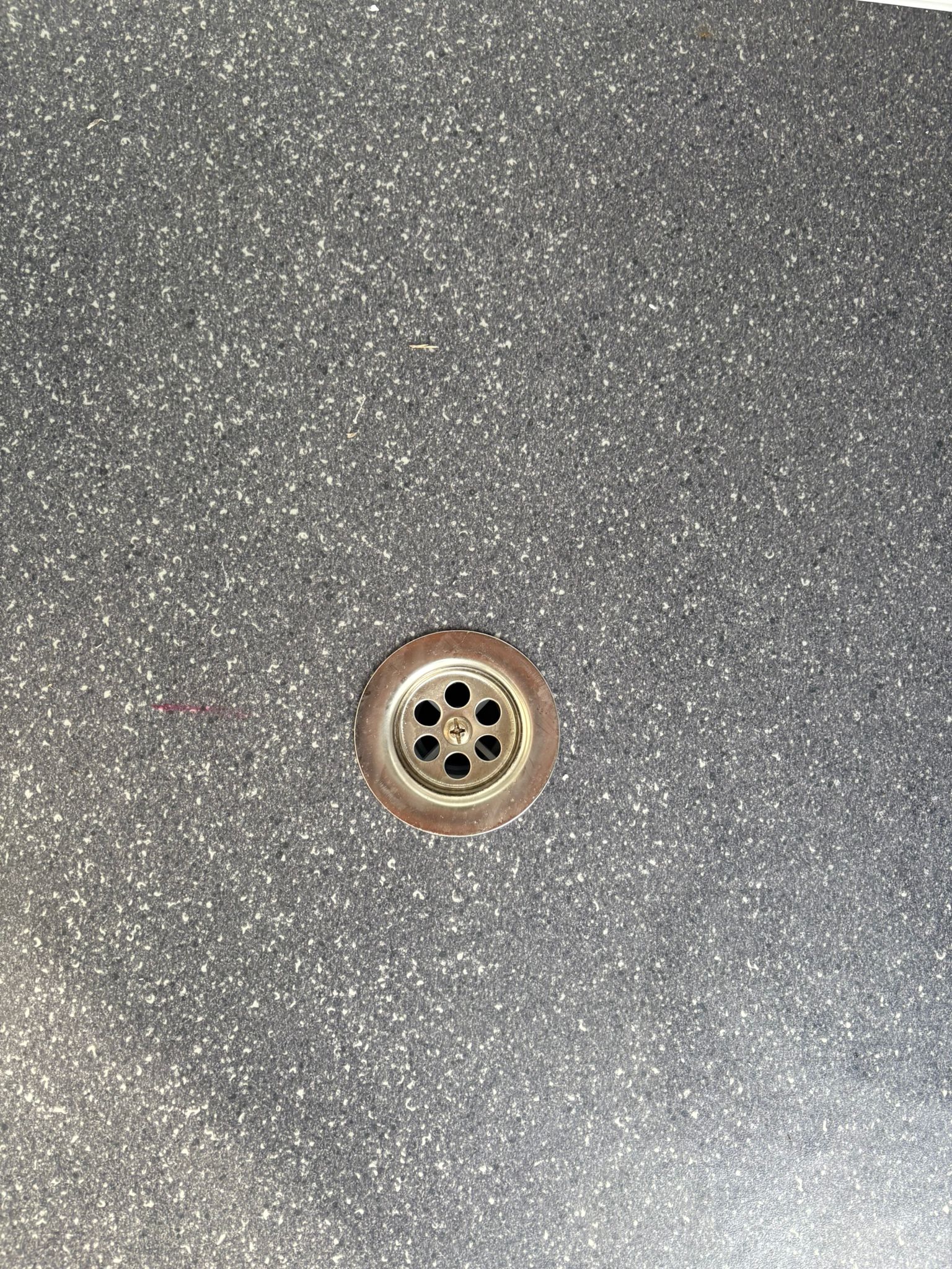 Vloerput van een doucheunit met omkleedruimte.